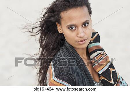 Picture - Mixed race woman wearing stylish sweater. Fotosearch