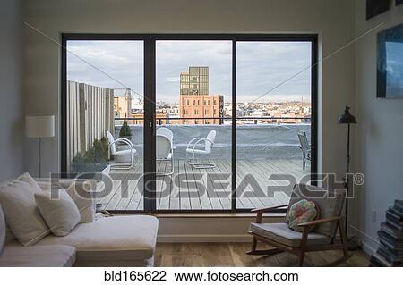 Modern living room and patio on urban rooftop, New York, New York, United States View Large Photo Image Stock Image - Modern living room and patio on urban rooftop, New York, New York, United States. Fotosearch