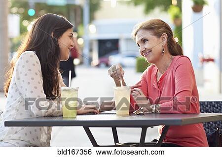 Mother and daughter drinking lemonade at sidewalk cafe View Large Photo Image Stock Photograph - Mother and daughter drinking lemonade at sidewalk cafe. Fotosearch