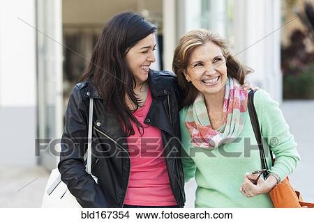 Picture - Mother and daughter walking outdoors. Fotosearch