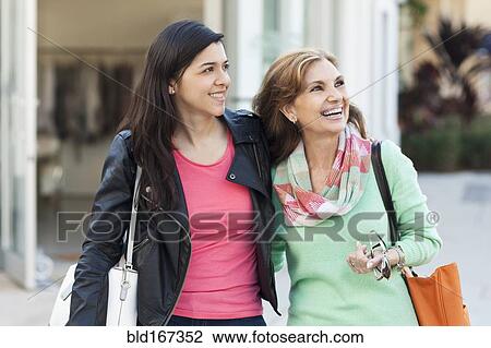 Mother and daughter walking outdoors View Large Photo Image Stock Image - Mother and daughter walking outdoors. Fotosearch