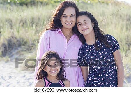 Mother and daughters smiling on beach View Large Photo Image Stock Photograph - Mother and daughters smiling on beach. Fotosearch