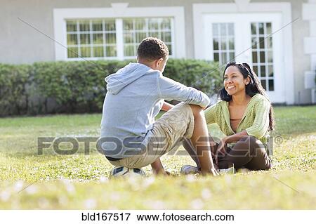 Mother and son talking in backyard View Large Photo Image Stock Photo - Mother and son talking in backyard. Fotosearch