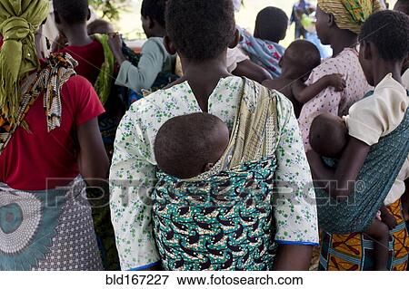 Mothers carrying children and waiting at rural health clinic View Large Photo Image Stock Photo - Mothers carrying children and waiting at rural health clinic. Fotosearch