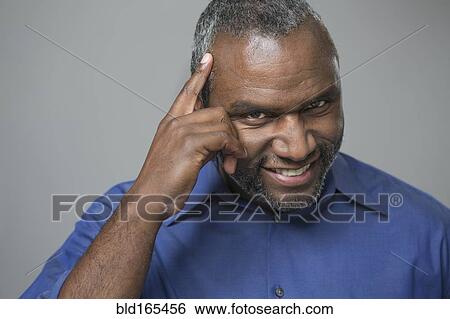 Older African American man tapping his forehead View Large Photo Image Stock Photograph - Older African American man tapping his forehead. Fotosearch