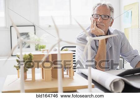 Older Caucasian architect examining scale model in office View Large Photo Image Stock Photograph - Older Caucasian architect examining scale model in office. Fotosearch