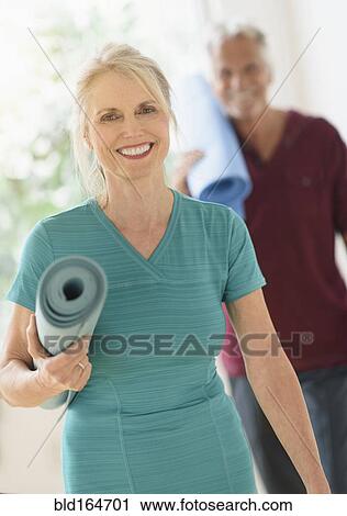 Older Caucasian couple carrying yoga mats View Large Photo Image Stock Image - Older Caucasian couple carrying yoga mats. Fotosearch