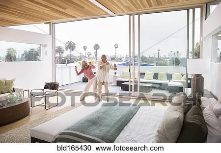 Stock Image - Older Caucasian couple dancing in bedroom. Fotosearch