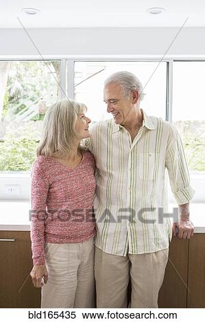 Older Caucasian couple hugging in kitchen View Large Photo Image Stock Photography - Older Caucasian couple hugging in kitchen. Fotosearch