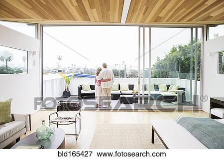 Older Caucasian couple hugging on porch View Large Photo Image Stock Photo - Older Caucasian couple hugging on porch. Fotosearch