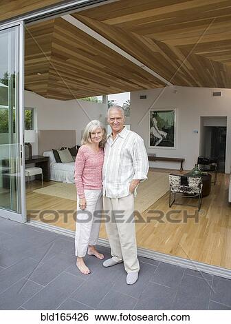 Stock Photograph - Older Caucasian couple smiling on porch. Fotosearch