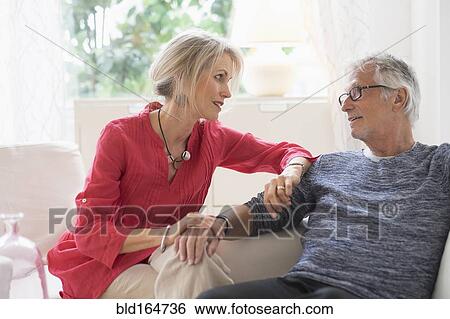 Older Caucasian couple talking in living room View Large Photo Image Stock Photograph - Older Caucasian couple talking in living room. Fotosearch