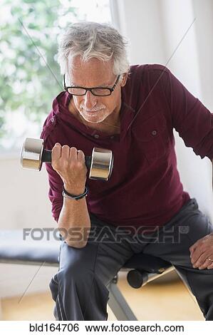 Older Caucasian man lifting weights in gym View Large Photo Image Stock Photograph - Older Caucasian man lifting weights in gym. Fotosearch