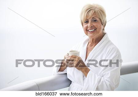 Older Caucasian woman drinking coffee on balcony View Large Photo Image Stock Photo - Older Caucasian woman drinking coffee on balcony. Fotosearch