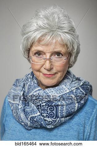 Older Caucasian woman peering over eyeglasses View Large Photo Image Picture - Older Caucasian woman peering over eyeglasses. Fotosearch