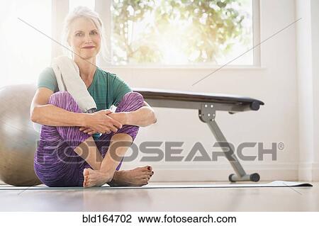 Older Caucasian woman sitting on gym floor View Large Photo Image Stock Image - Older Caucasian woman sitting on gym floor. Fotosearch