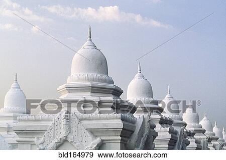 Stock Photo - Ornate domes under cloudy sky, Mandalay, Myanmar. Fotosearch