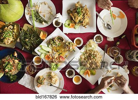 Stock Photograph - Overhead view of seafood and salad dishes on table. Fotosearch