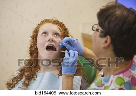 Pediatric dentist examining teeth of teenage patient View Large Photo Image Stock Photography - Pediatric dentist examining teeth of teenage patient. Fotosearch