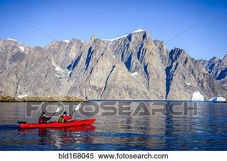 People paddling canoe near rock formations in remote river View Large Photo Image Stock Photography - People paddling canoe near rock formations in remote river. Fotosearch