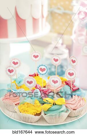 Picture - Plate of cupcakes at birthday party. Fotosearch