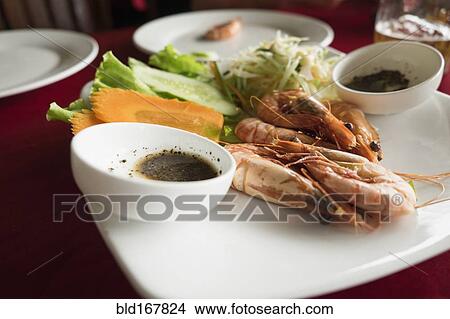 Plate of shrimp, carrot and salad on restaurant table View Large Photo Image Picture - Plate of shrimp, carrot and salad on restaurant table. Fotosearch