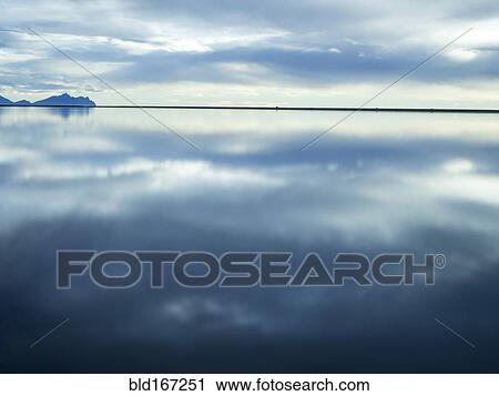 Reflection of clouds in still water View Large Photo Image Stock Image - Reflection of clouds in still water. Fotosearch