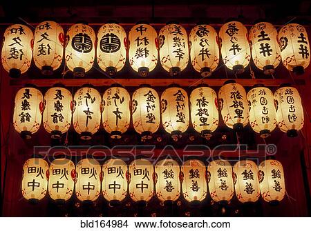 Picture - Rows of illuminated prayer lanterns at night. Fotosearch
