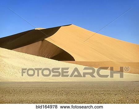 Stock Photo - Sand dunes under blue sky in Namib-Naukluft National Park, Namib Desert, Namibia. Fotosearch
