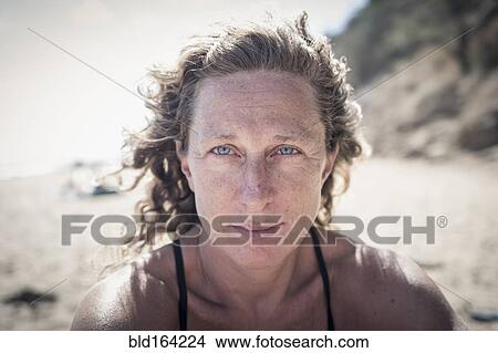 Picture - Serious Caucasian woman on beach. Fotosearch