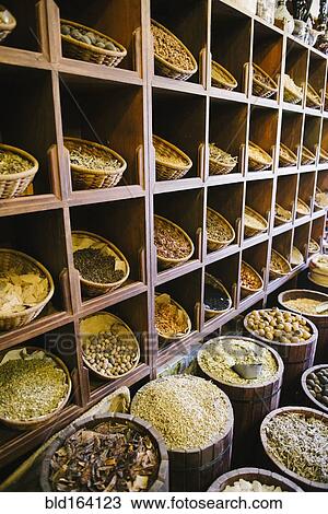 Stock Image - Shelves of sacks of grain for sale in market. Fotosearch