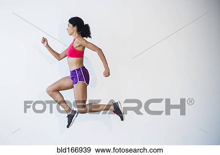 Stock Photo - Side view of mixed race woman running. Fotosearch