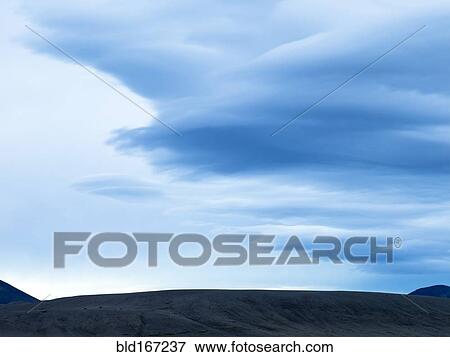 Silhouette of mountain range under cloudy sky View Large Photo Image Stock Photo - Silhouette of mountain range under cloudy sky. Fotosearch