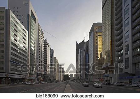 Stock Image - Silhouette of ornate domes and columns under hazy sky, Abu Dhabi, Abu Dhabi Emirate, United Arab Emirates. Fotosearch