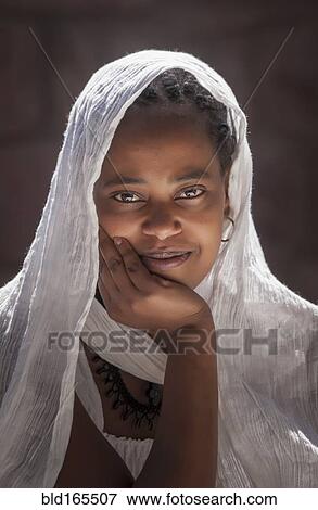 Smiling Black girl wearing headscarf View Large Photo Image Stock Photo - Smiling Black girl wearing headscarf. Fotosearch