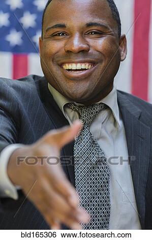 Stock Photograph - Smiling Black politician offering handshake. Fotosearch