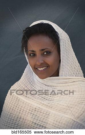 Smiling Black woman wrapped in scarf View Large Photo Image Stock Photography - Smiling Black woman wrapped in scarf. Fotosearch