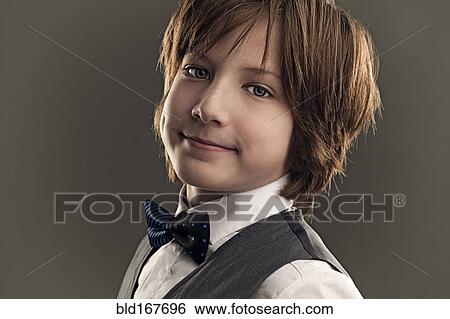 Smiling boy wearing dress shirt and bow tie View Large Photo Image Stock Photograph - Smiling boy wearing dress shirt and bow tie. Fotosearch