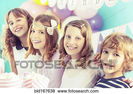 Smiling children hugging at birthday party View Large Photo Image Stock Photo - Smiling children hugging at birthday party. Fotosearch