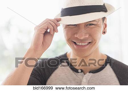 Smiling Chinese man wearing straw hat View Large Photo Image Stock Photo - Smiling Chinese man wearing straw hat. Fotosearch