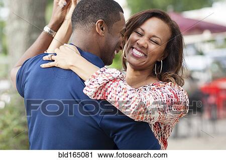 Smiling couple dancing on sidewalk View Large Photo Image Stock Image - Smiling couple dancing on sidewalk. Fotosearch