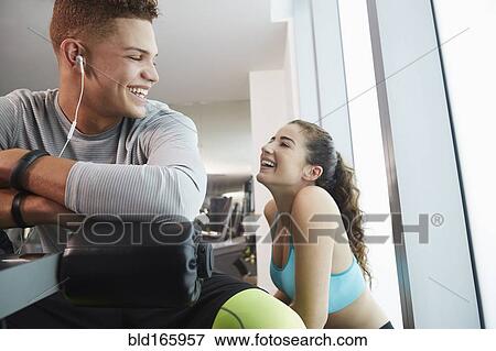 Stock Photo - Smiling couple laughing in gym. Fotosearch