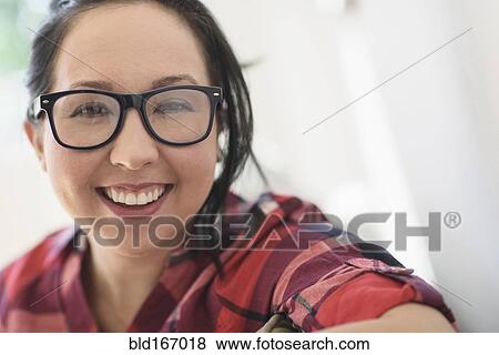 Stock Photo - Smiling mixed race woman wearing eyeglasses. Fotosearch