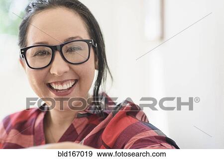 Smiling mixed race woman wearing eyeglasses View Large Photo Image Stock Photo - Smiling mixed race woman wearing eyeglasses. Fotosearch
