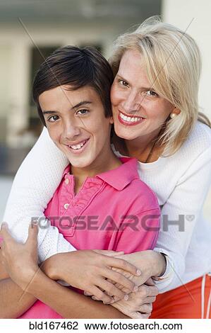 Smiling mother and son hugging outdoors View Large Photo Image Stock Image - Smiling mother and son hugging outdoors. Fotosearch