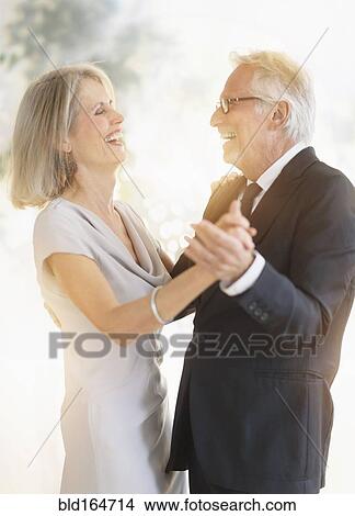 Smiling older Caucasian couple dancing View Large Photo Image Picture - Smiling older Caucasian couple dancing. Fotosearch