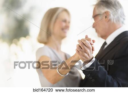 Smiling older Caucasian couple dancing View Large Photo Image Stock Image - Smiling older Caucasian couple dancing. Fotosearch