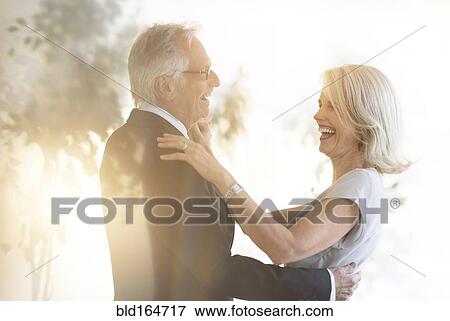 Smiling older Caucasian couple dancing View Large Photo Image Stock Photo - Smiling older Caucasian couple dancing. Fotosearch