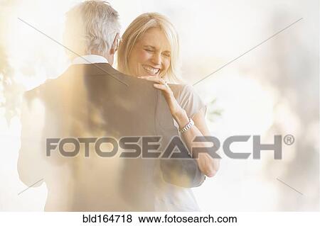 Stock Photo - Smiling older Caucasian couple dancing. Fotosearch