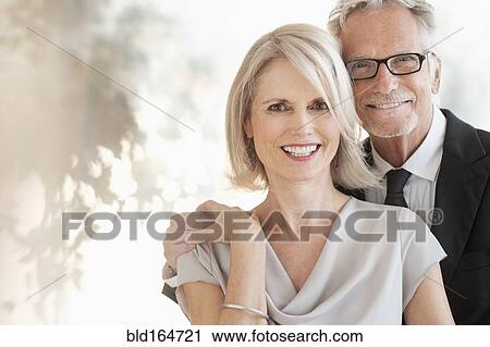 Smiling older Caucasian couple hugging View Large Photo Image Stock Image - Smiling older Caucasian couple hugging. Fotosearch